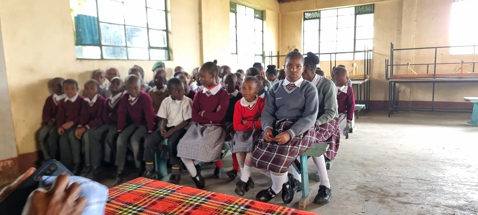 Pupils seated together in the school hall